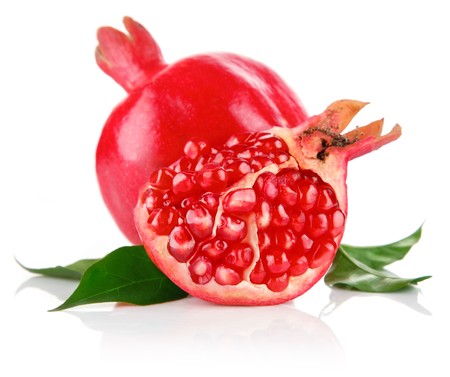 pomegranate fresh fruits with cut and green leaves isolated on white backgroundの写真素材