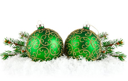 green balls on snow with branch firtree isolated white backgroundの写真素材