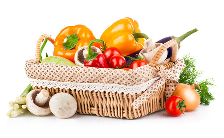 Fresh vegetables in wicker basket. Isolated on white backgroundの写真素材