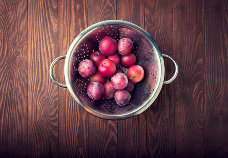 Fresh ripe plums on wooden boardの写真素材