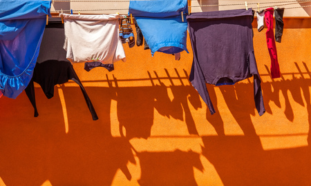 Clothes on rope dry after wash with shadowの写真素材