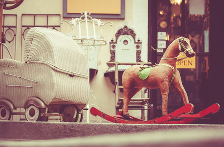 Retro baby carriage and toy rocking-horse antique saleの写真素材