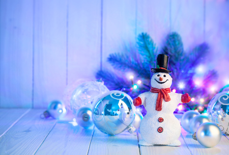 Christmas snowman with balls and garland on wooden boardの写真素材