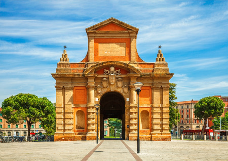 Medieval ancient gates entrance to old town of Bologna city, Italy. Big square piazza area with lanterns and big trees. Famous landmark object.の写真素材