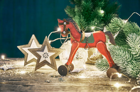 Christmas card with firtree balls and red wooden horse white snow copyspace.の写真素材