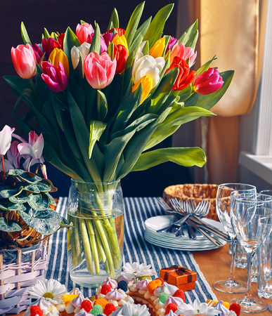 Spring tulips flowers bouquet on the table, romantic greeting gift for birthday or Saint Valentines day holidayの写真素材