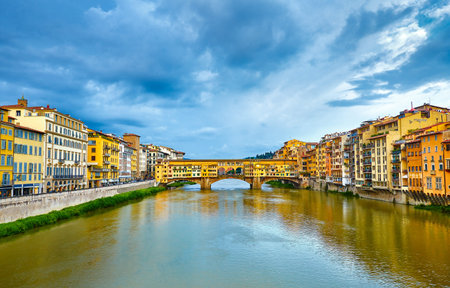 Panorama view to ancient bridge Ponte Vecchio at river Arno in Florence old town, famous touristic place of Tuscany region, Italyの写真素材