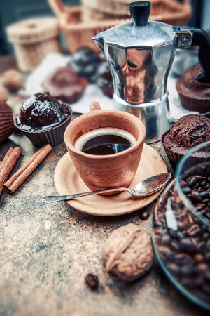 Crafting coffee in clay cup with bean cezve and chocolate cake on grunge background.の写真素材