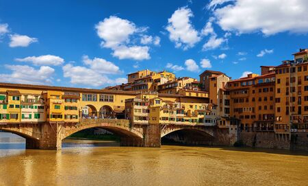Panorama view to ancient bridge Ponte Vecchio at river Arno in Florence old town, famous touristic place of Tuscany region, Italy.の写真素材