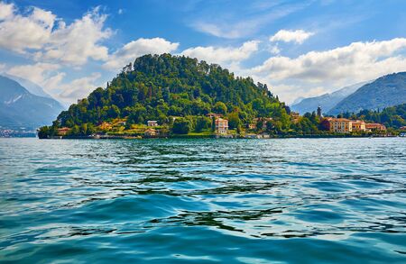 Bellagio village at lake Como, Italy. Panoramic view at hill with park and antique city among mountains and green forests.の写真素材