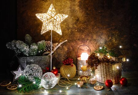 Christmas holiday decoration with shining star, fir, snow, balls and vintage toys with garland.の写真素材