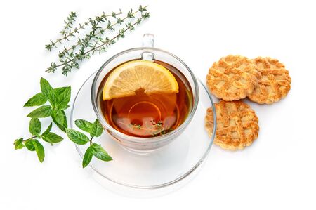 Tea with herb leaf mint thyme and cookies Isolated on whiteの写真素材