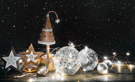 Christmas fir-tree with Festive decor in rustic style at wooden board with gold bell.の写真素材