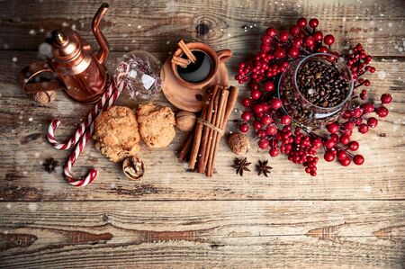 Black coffee with cookies cinnamon and spice on old wooden board in rustic styleの写真素材