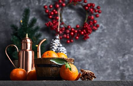 Christmas card with tangerines festive decor and firtree on old wooden board in rustic style.の写真素材