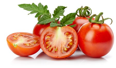 Tomato in cut with leaf for packaging and label. Still life harvest vegetable.の写真素材