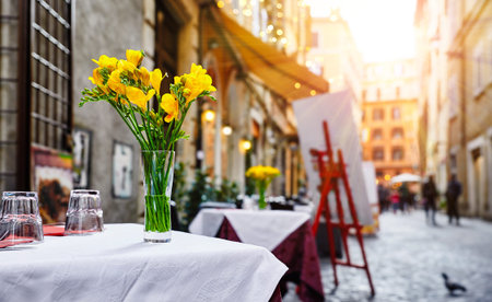 Rome Italy. Street near Trevi Fountain. Picturesque landscape old town with restaurants, shop-window shop, table cafe with bunch flower.の写真素材