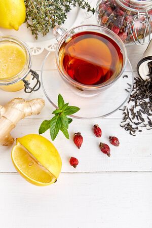 Ginger tea with lemon honey Rose Hip and thyme at white wooden board in rustic style. Top view.の写真素材
