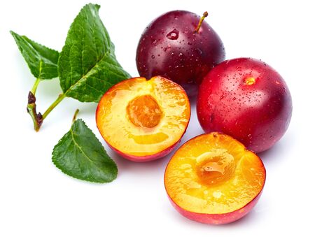 Fresh plum in cut with green leaf. Fruity still life. Healthy food. Isolated on white background.の写真素材
