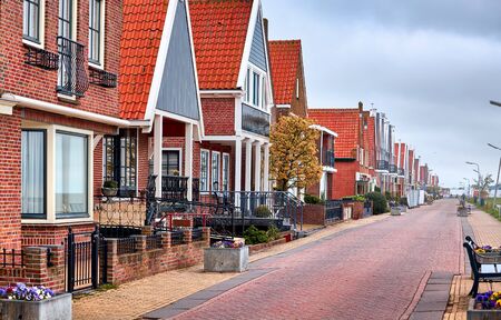 Fishing village Volendam panoramic view Holland Netherlands. Small wooden houses blue sky clouds.の写真素材
