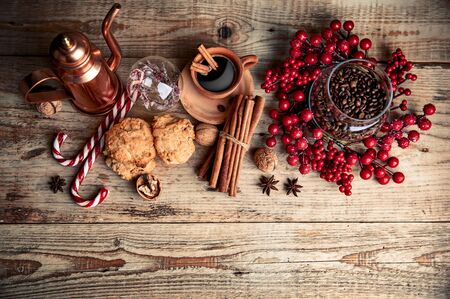 Black coffee with cookies cinnamon and spice on old wooden board in rustic style, top view.の写真素材