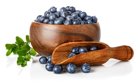 Berry blueberry in wooden plate with green leaf. Fruity still life. Healthy eating, isolated on white background.の写真素材