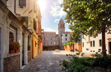 Venice Italy. Picturesque yard old town with tower and vintage houses. Sunny day.の写真素材