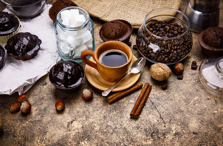 Crafting coffee in clay cup with bean cezve and chocolate cake top view on grunge background.の写真素材