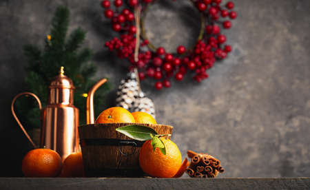 Christmas card with tangerines festive decor and firtree on old wooden board in rustic style.の写真素材