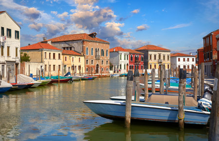 Island Murano in Venice Italy. View on canal with boat and motorboat water. Picturesque landscape.の写真素材