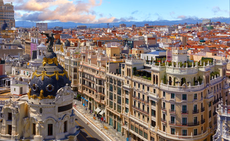 Madrid, Spain. Downtown district where the Calle de Alcala meets the Gran Via street. Most famous and busy streets in Madrid. Dramatic sky with cloudsの写真素材