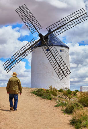 Wind mill at knolls at Consuegra, Toledo region, Castilla La Mancha, Spain. Route of Don Quixote with windmills. Summer landscape with blue sky and clouds.の写真素材