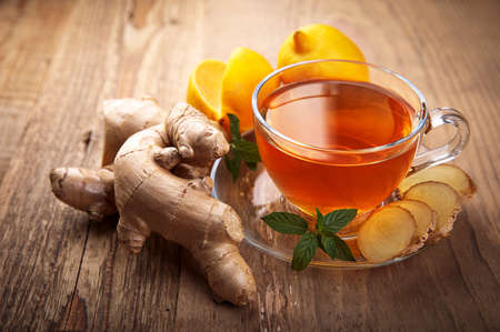 Ginger tea with lemon honey and thyme at white wooden board in rustic style. Top view.の写真素材