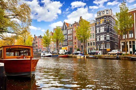 Channel in Amsterdam Netherlands houses river Amstel landmark old european city spring landscape.の写真素材