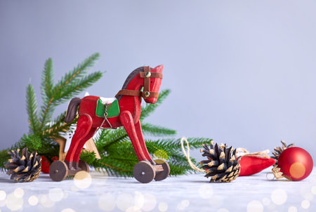 Christmas card with vintage wooden horse decoration for christmas tree and garland at old board.の写真素材