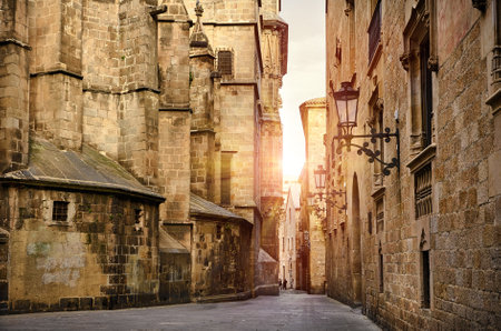 Gothic Quarter in Barcelona Catalonia Spain. Antique lamps on the narrow streets with medieval buildings. Ancient architecture of old town stone houses. Evening sky and antique street lanternsの写真素材