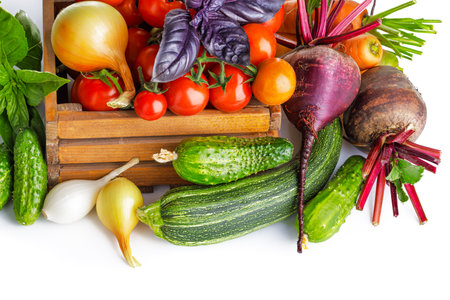Fresh vegetables in basket. Isolated on white backgroundの写真素材