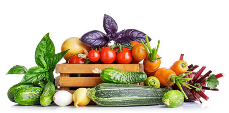 Fresh vegetables in basket. Isolated on white backgroundの写真素材