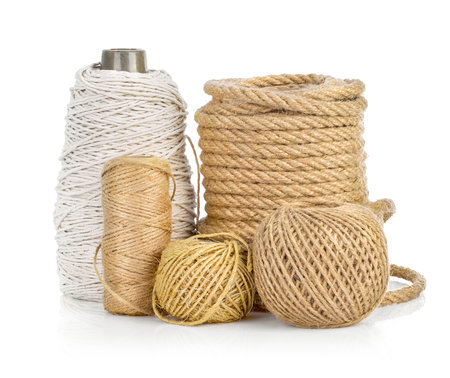 Craft jute rope bundles. Tools set for hand made creative work or decor. Isolated on white background.の写真素材