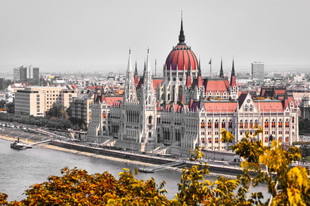 Budapest city, Hungary. Building of Hungarian parliament. Danube river. Autumn trees with yellow leaves. Vintage retro photo.の写真素材