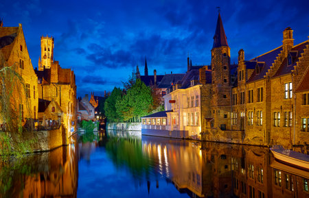 Bruges, Belgium. Channel Rozenhoedkaai. Panoramic view at Perez de Malvenda house and Belfort tower. Blue hour evening time. Famous travel destination in Europe.の写真素材