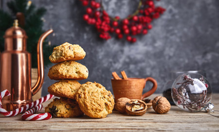 Homemade cookies with cup coffee nuts and copper coffeepot on old wooden board in rustic style....