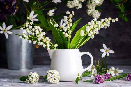 Bouquet spring white Lily of the valley. Floral still life on gray wooden board table in rustic style. Blooming branch bush with flowerbed gardening flower-growing.の写真素材