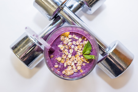 Dumbbell .bodybuilding supplements . Fitness,healthy lifestyle concept. Good for Gym, Sport, delicious berry fitness cocktail with oats, oatmeal with mint.の写真素材