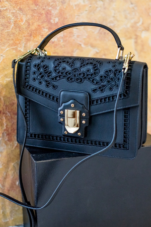 Elegant black female bag over white background. Vintage black clutch isolated.の写真素材
