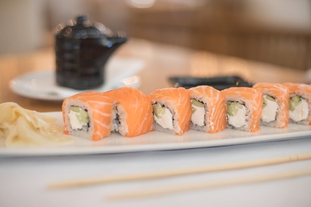 Delicious fresh sushi rolls with salmon and philadelphia cheese on white plate.Traditional japanese seafood, healthy food concept.Philadelphia classic sushi rollの写真素材