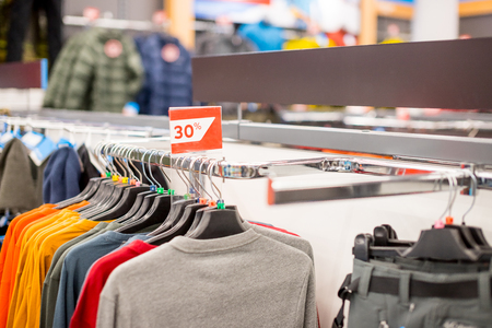 discount sign on clothing store. Sticker sign - Sale up to 30 percent on store with clothes during winter, spring sale season time. Selective focusの写真素材