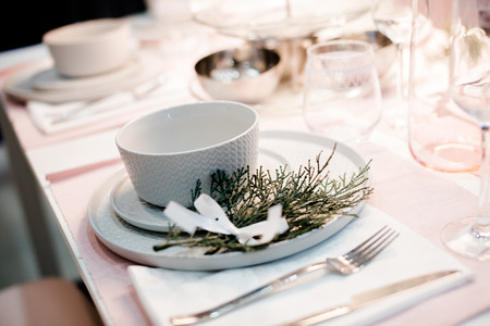 Table setting in white color, with decoration of green. Table setting for event party or wedding. Decor in green and white colors.Catering in restaurant.の写真素材