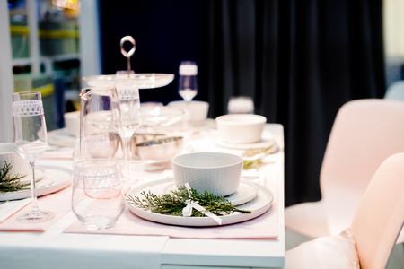 Table setting in white color, with decoration of green. Table setting for event party or wedding. Decor in green and white colors.Catering in restaurant.の写真素材