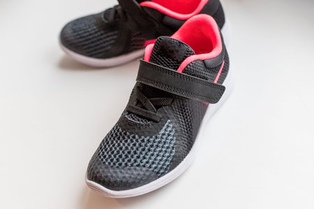 New pink, black sport shoes isolated on white background.kids running shoes. Childrens running shoes. Isolated on a white background.small child sport shoes. freestyle comfortの写真素材